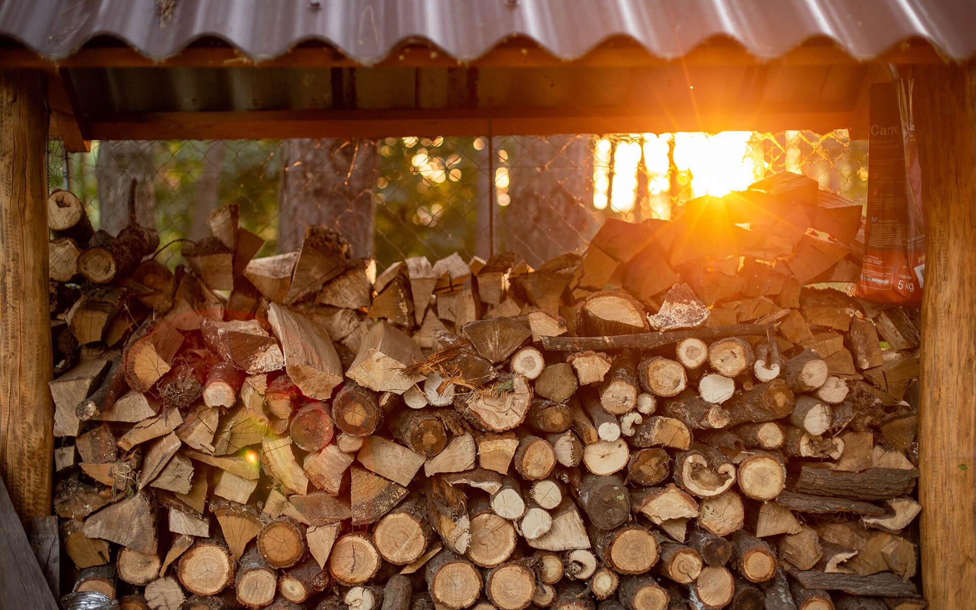 DIY Firewood Storage. Stack of firewood in a shed.